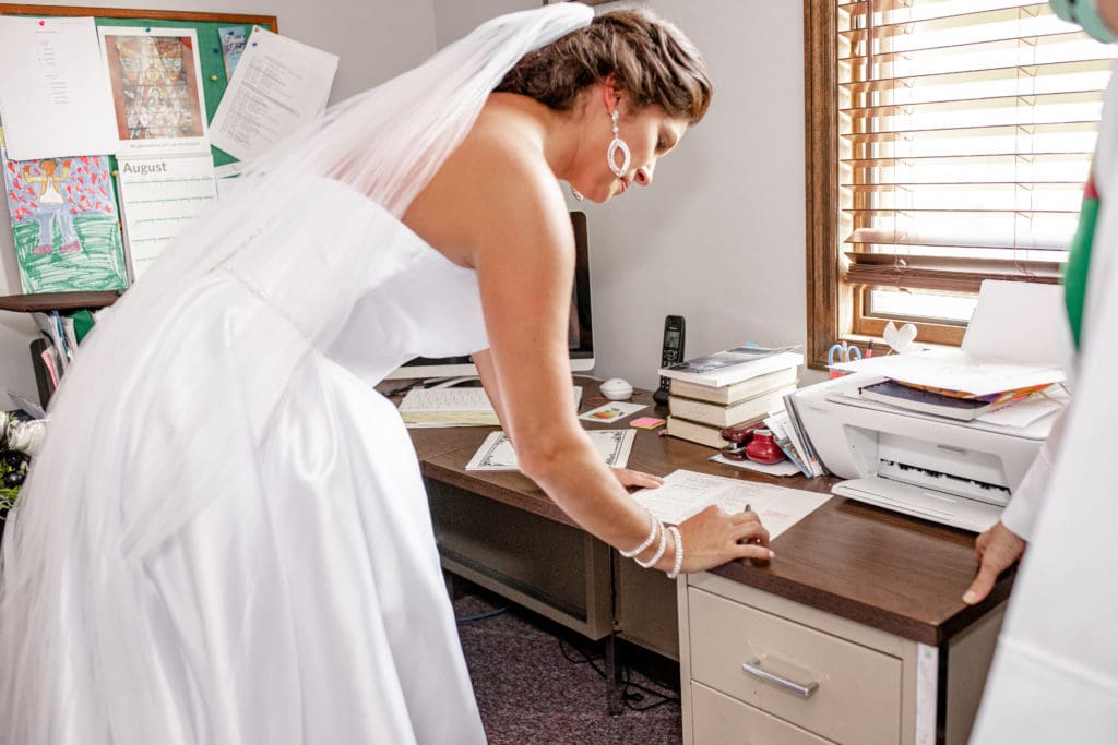 bride signing the marriage license