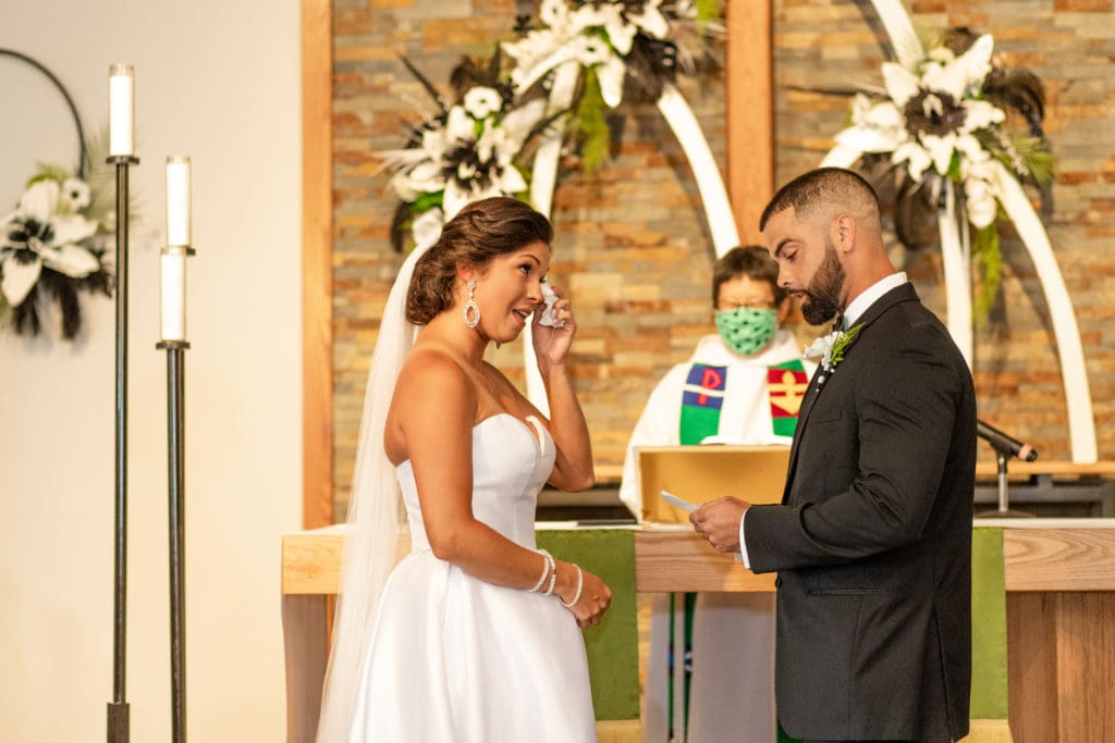 bride and groom at altar, bride and groom say i do, Lutheran wedding, Lutheran church, exchanging rings